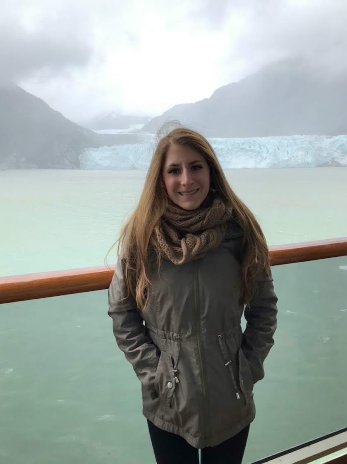 A picture of me standing in front of Glacier Bay. It was a bit rainy, so one of my best Alaska cruise tips is to prepare for such weather.