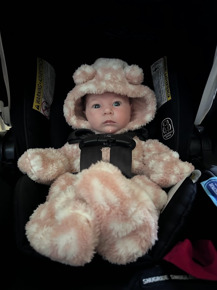 A fluffy onesie should be added to your newborn baby road trip packing list is you are traveling somewhere cold