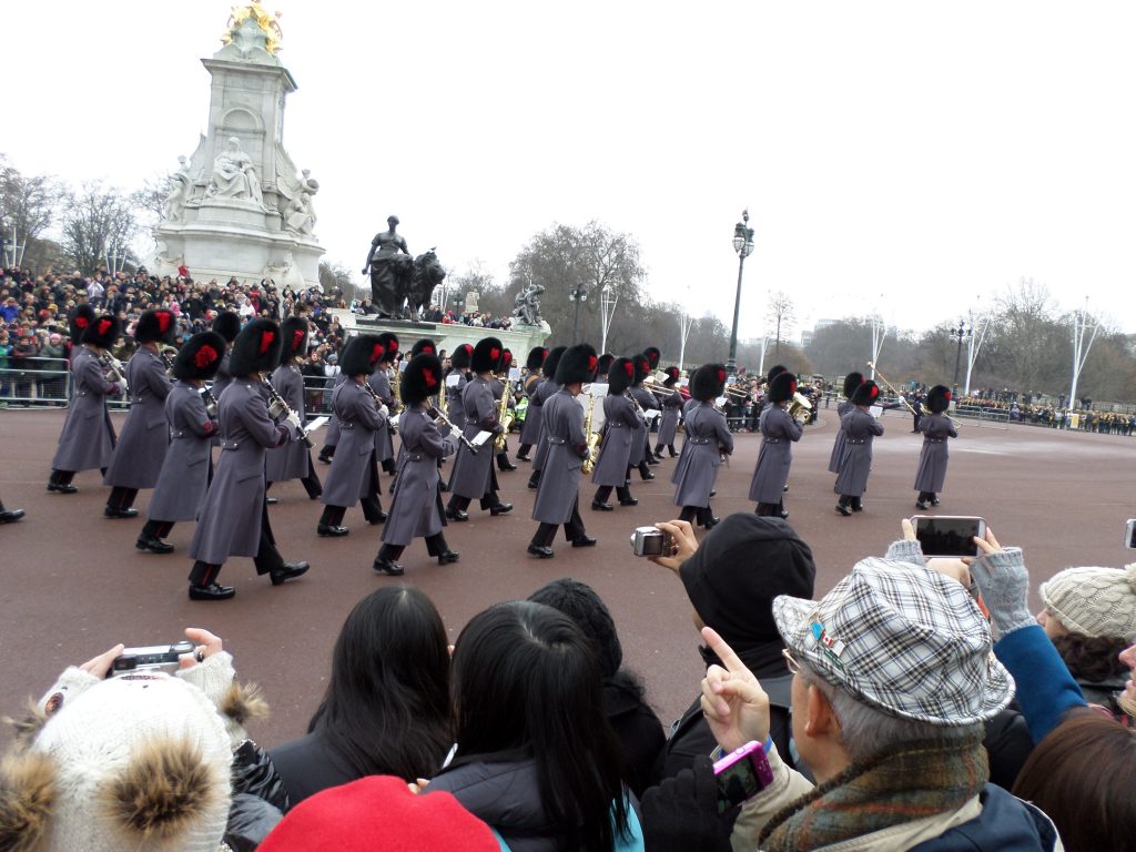 Guards walking outside of Buckingham Palace in London.