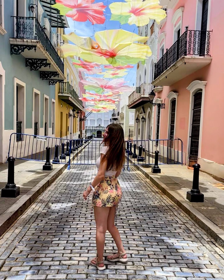 Julia walking down Calle de La Fortaleza in Old San Juan, Puerto Rico. Calle de La Fortaleza is one of the most popular things to do in Puerto Rico.