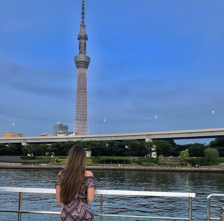 Picture of Julia looking out to the city of Tokyo from a boat. A sightseeing cruise is one of the best things to do in Tokyo to say goodbye.