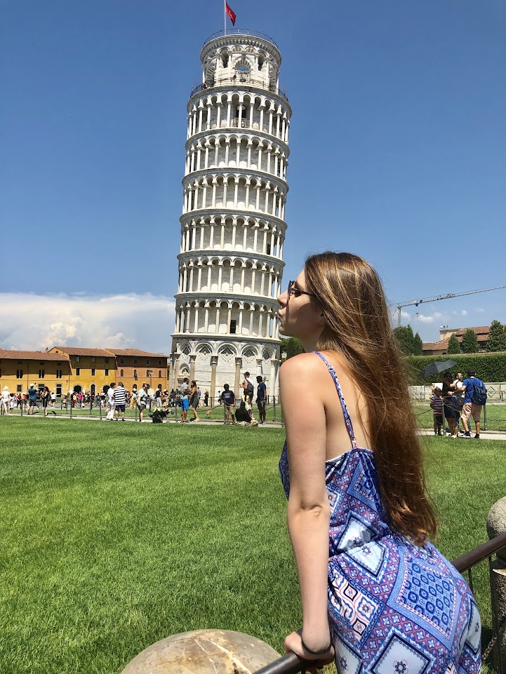 Picture of Julia visiting the Leaning Tower of Pisa in Pisa, Italy, which is one of the most popular places to go on a day trip from Florence. 